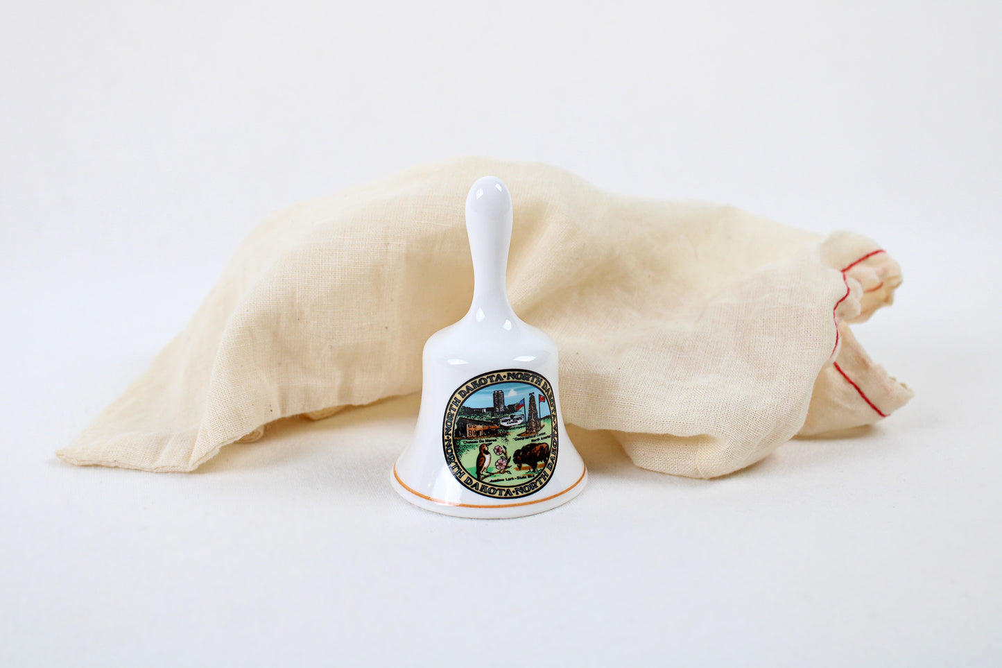 North Dakota Ceramic Souvenir Bell With State Emblems And Sites