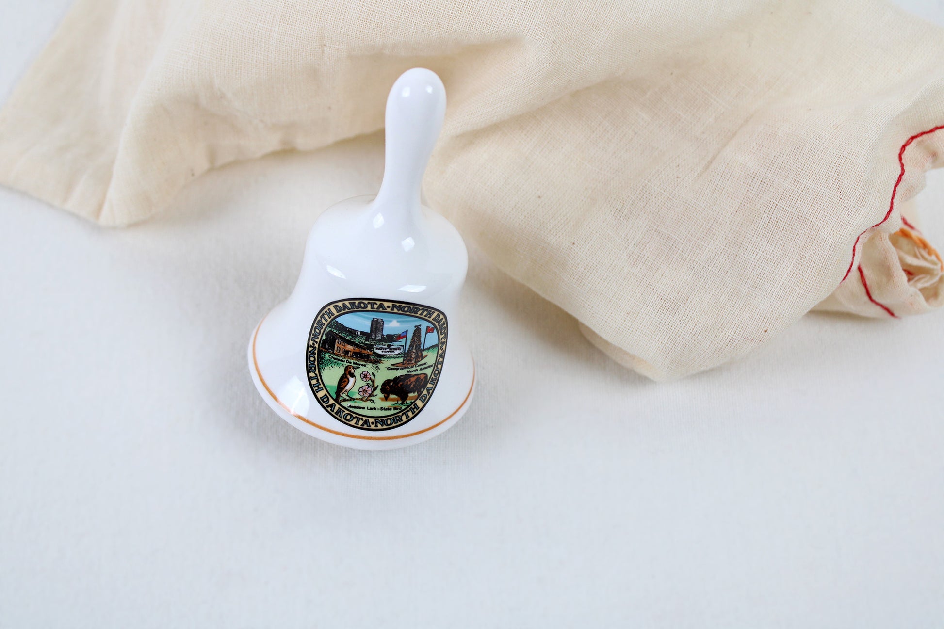 North Dakota Ceramic Souvenir Bell With State Emblems And Sites