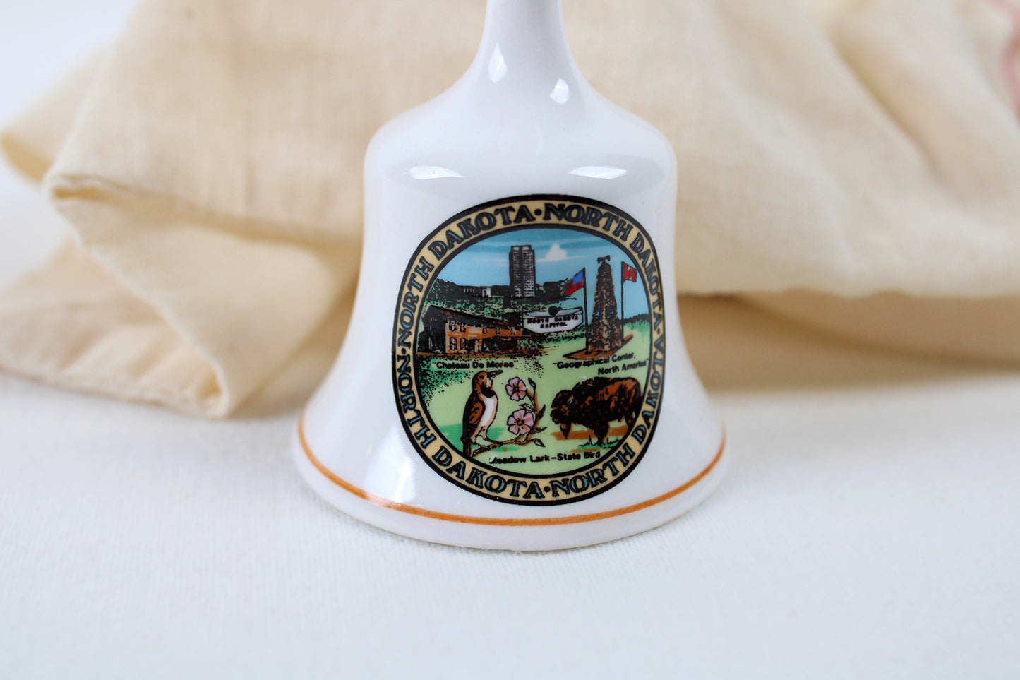 North Dakota Ceramic Souvenir Bell With State Emblems And Sites