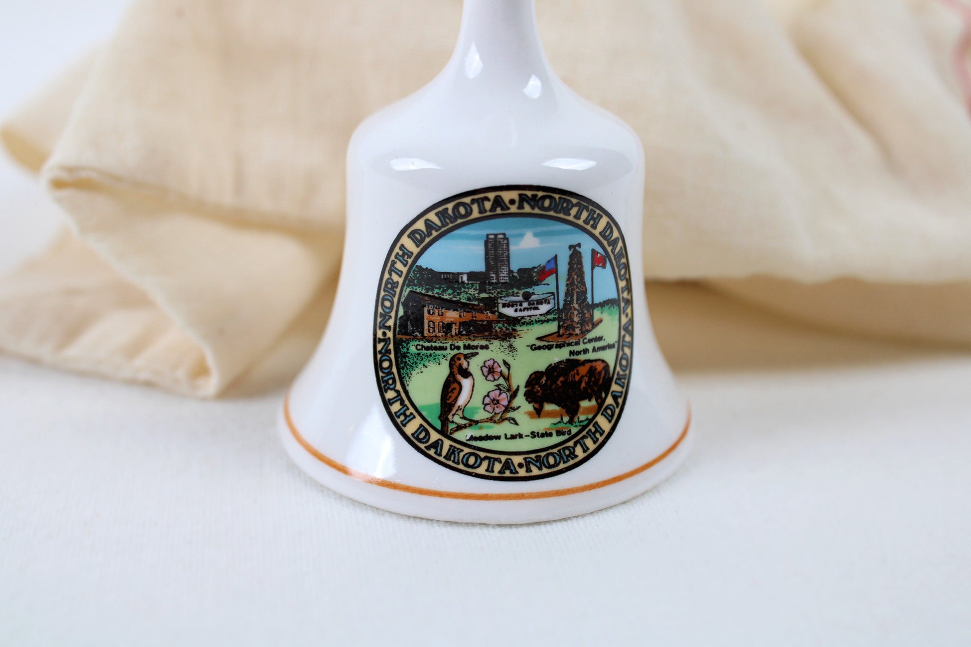 North Dakota Ceramic Souvenir Bell With State Emblems And Sites