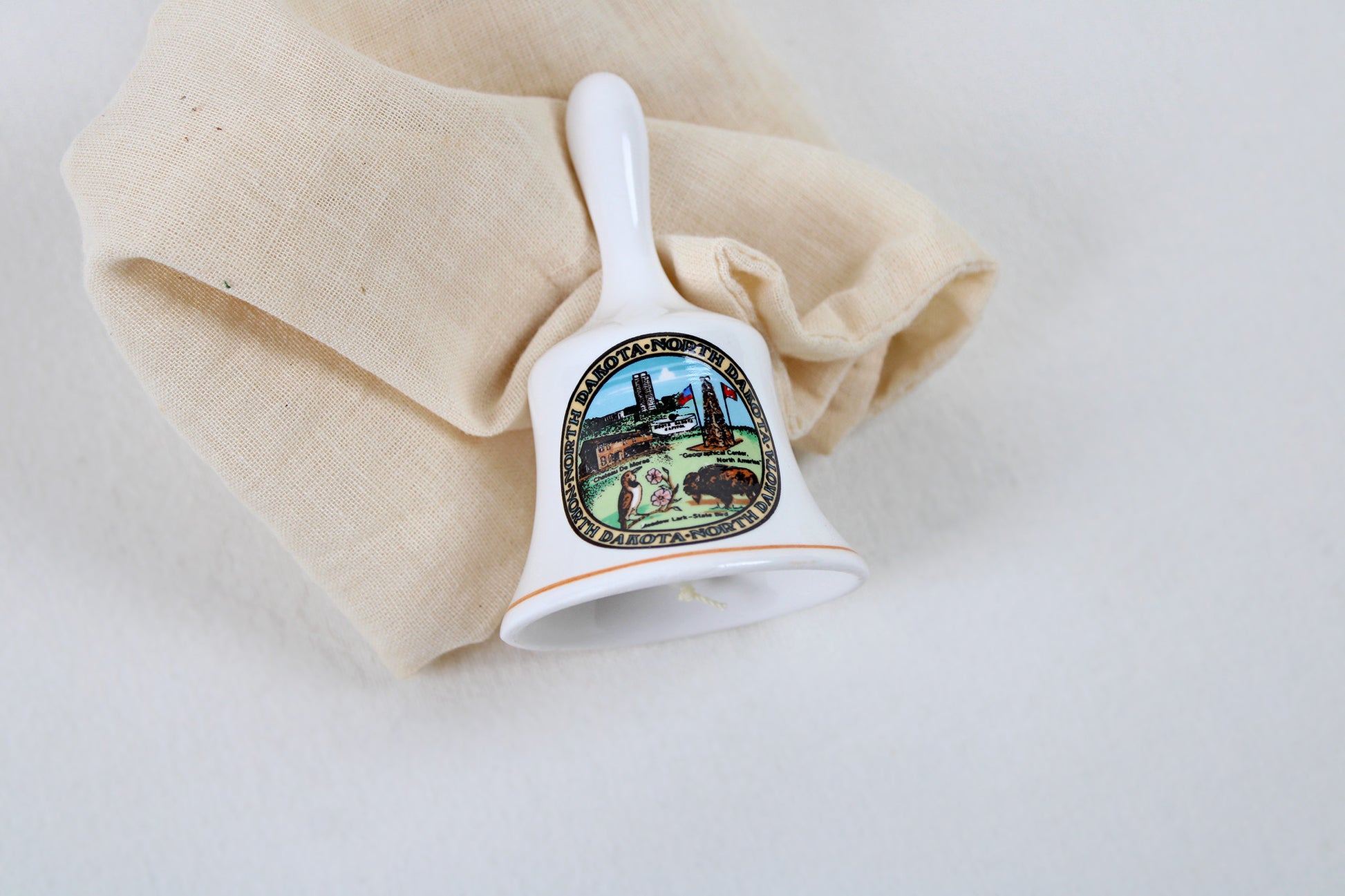 North Dakota Ceramic Souvenir Bell With State Emblems And Sites