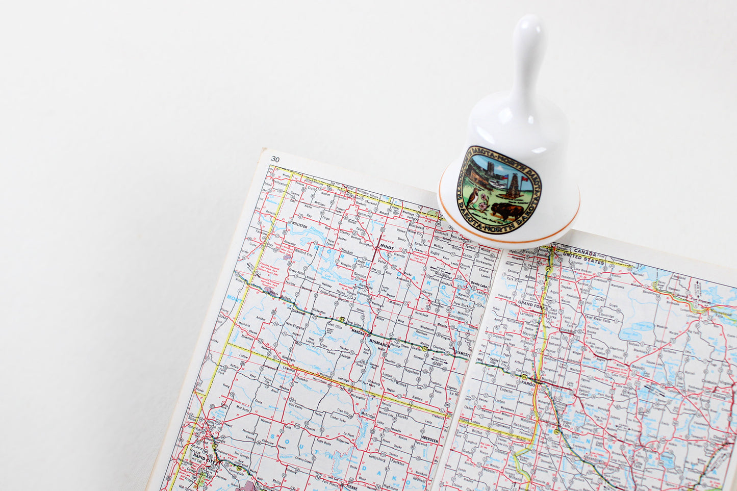 North Dakota Ceramic Souvenir Bell With State Emblems And Sites