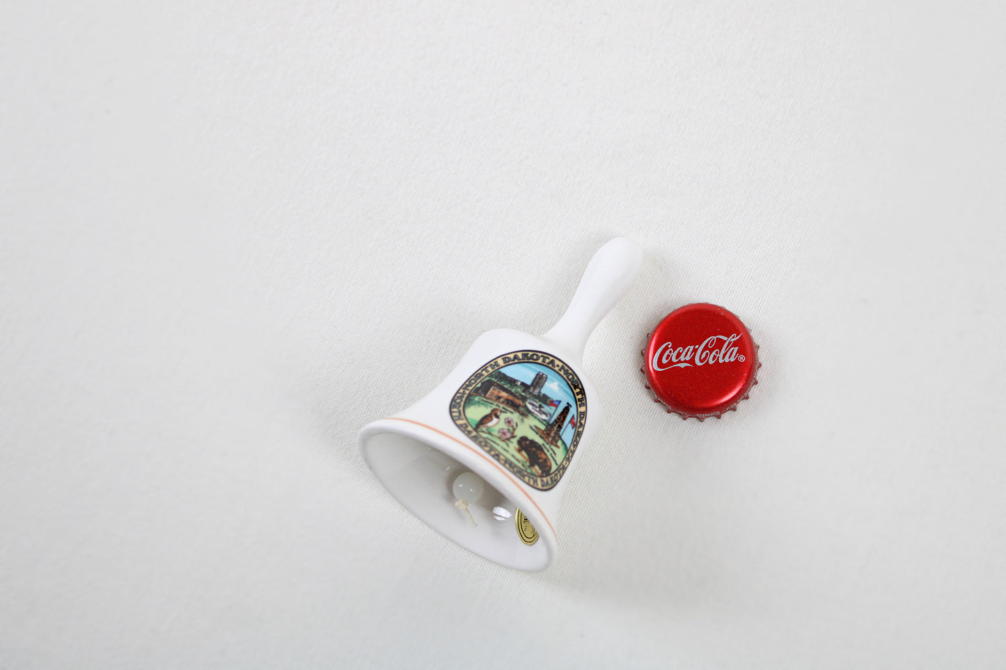 North Dakota Ceramic Souvenir Bell With State Emblems And Sites