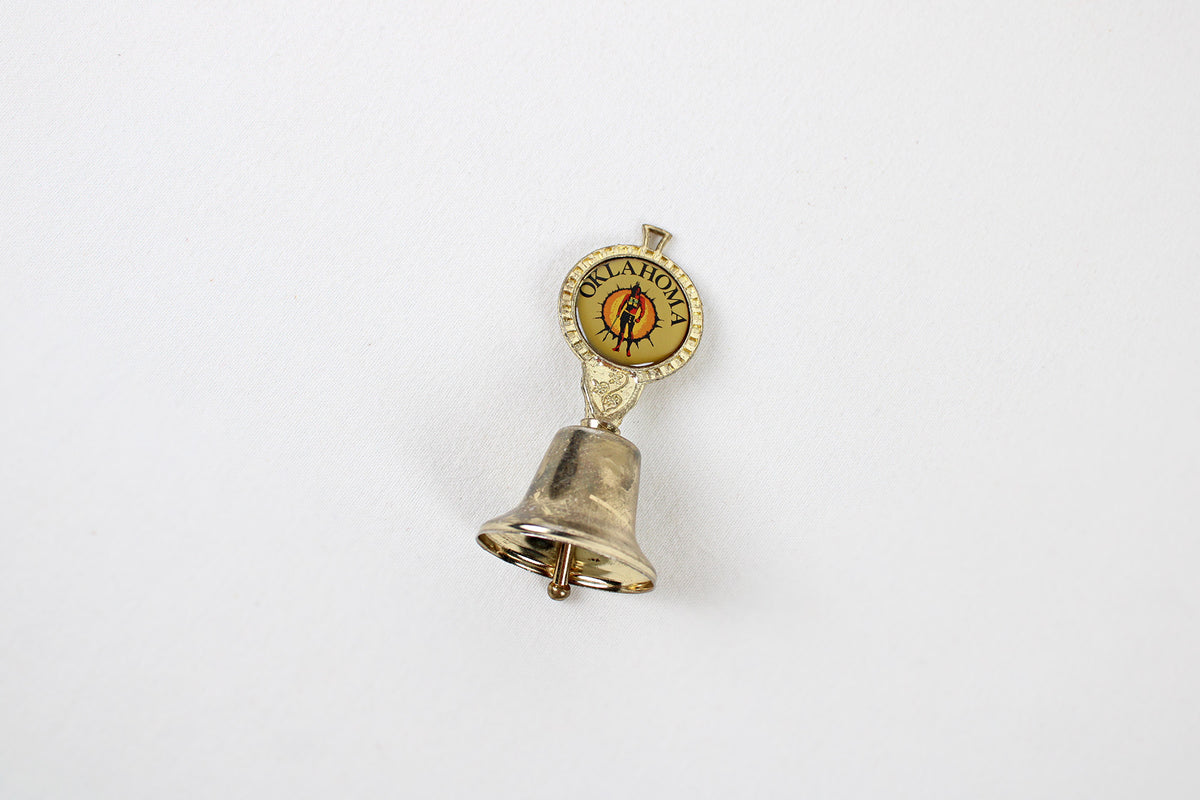 Oklahoma Metal Bell With Emblem Of Indian Warrior Against A Sun Symbol