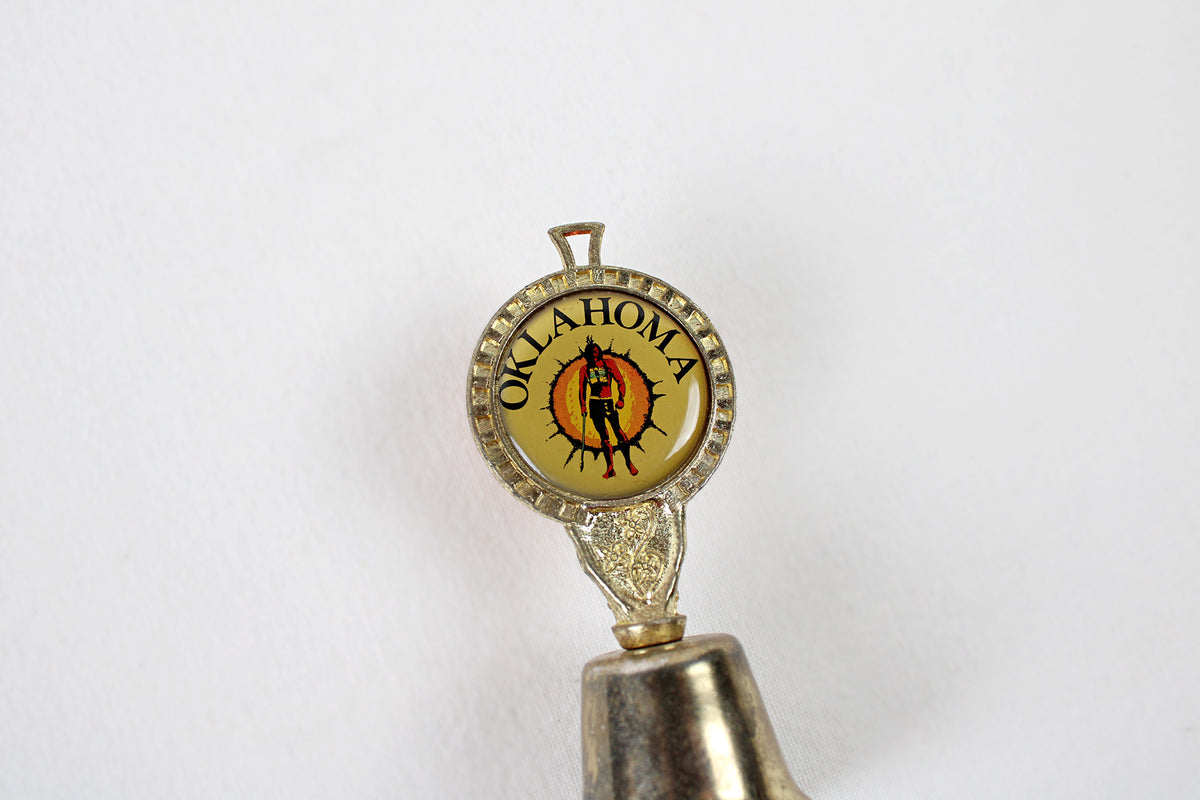Oklahoma Metal Bell With Emblem Of Indian Warrior Against A Sun Symbol