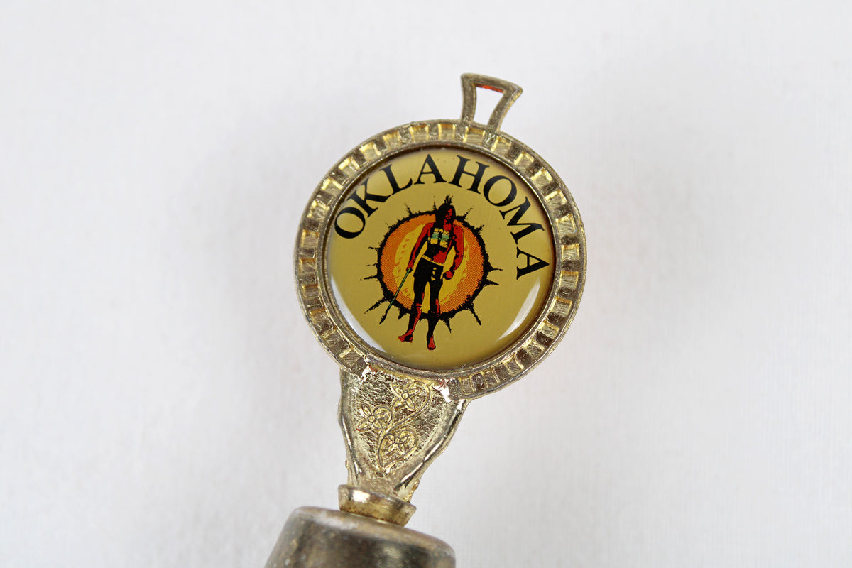 Oklahoma Metal Bell With Emblem Of Indian Warrior Against A Sun Symbol