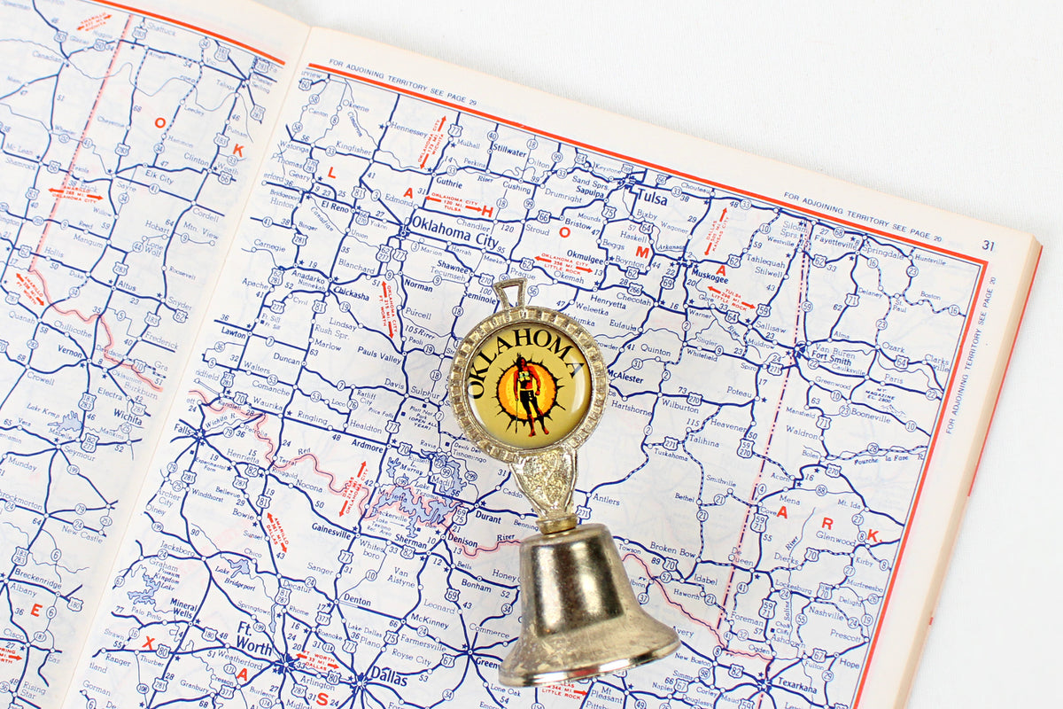 Oklahoma Metal Bell With Emblem Of Indian Warrior Against A Sun Symbol